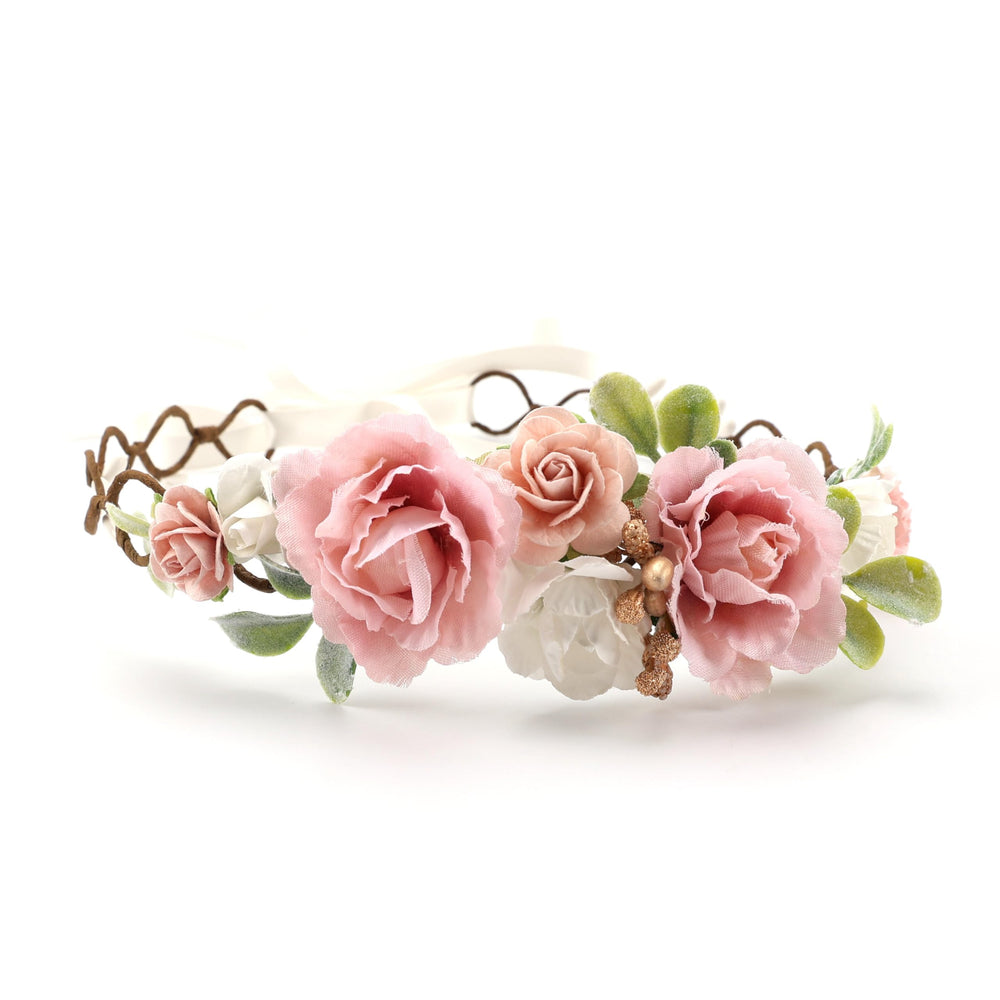 Handcrafted pastel blooms in blush pink, peach, and ivory for birthday photos.