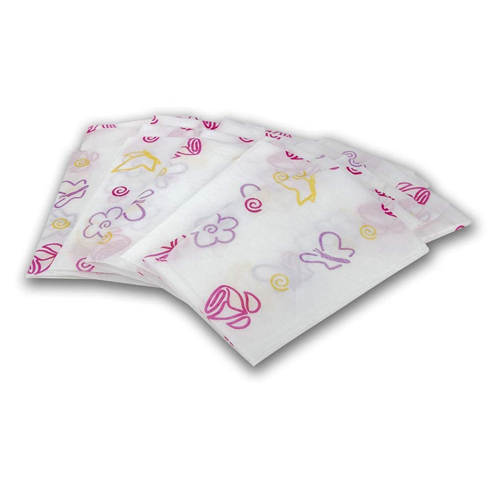 Potty Shields floral XL cover shown beside a travel bag for trips