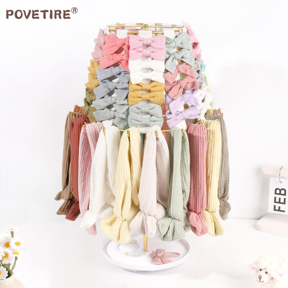 POVETIRE baby accessory organizer rack showcasing clips, bows, and headbands.