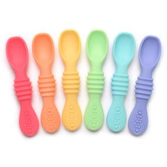 PrimaStella Summer Rainbow chew spoon in use, helping baby practice self-feeding with a safe grip.