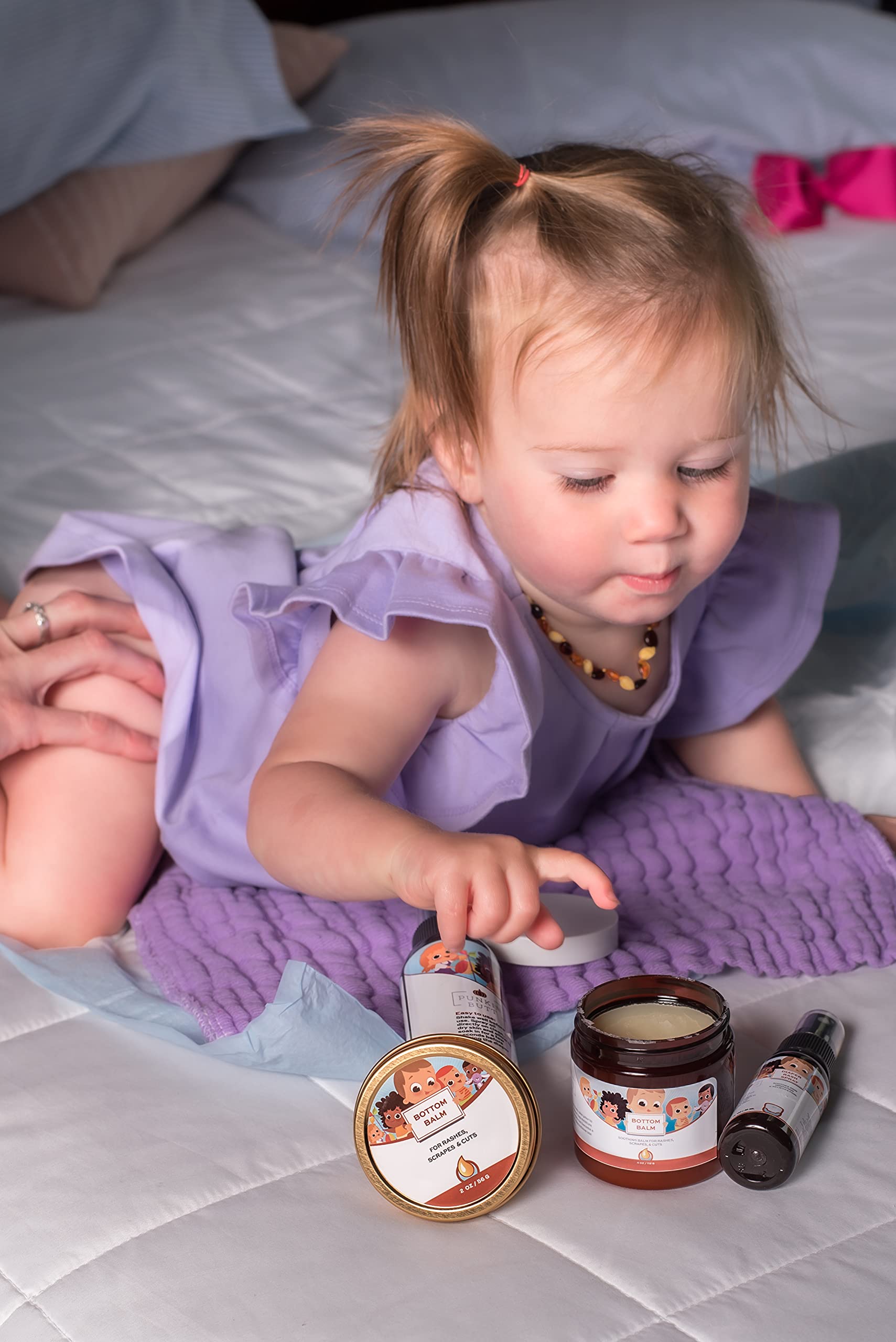 Punkin Butt Bottom Balm on baby diaper area shows soothing protection.