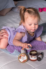 Punkin Butt Bottom Balm on baby diaper area shows soothing protection.