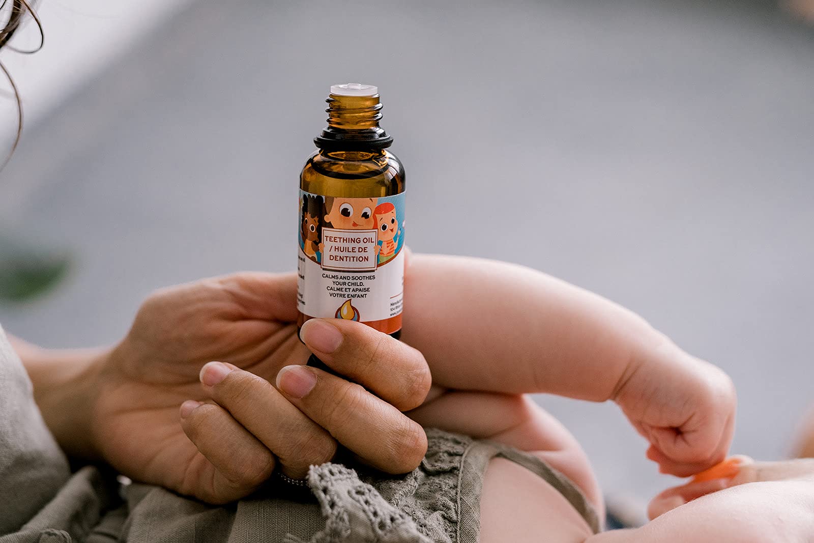 Punkin Butt Teething Oil packaging showcases 2 oz bottle and no added chemicals claim.