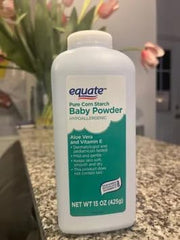 Pure Equate cornstarch baby powder label close-up emphasizes hypoallergenic formula.