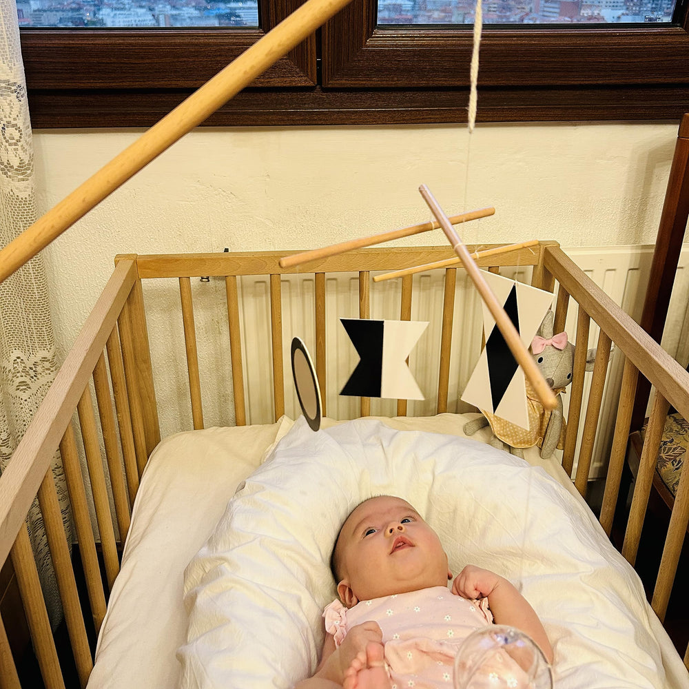 Purgano Octahedron rotates above crib, encouraging visual focus and calm play.