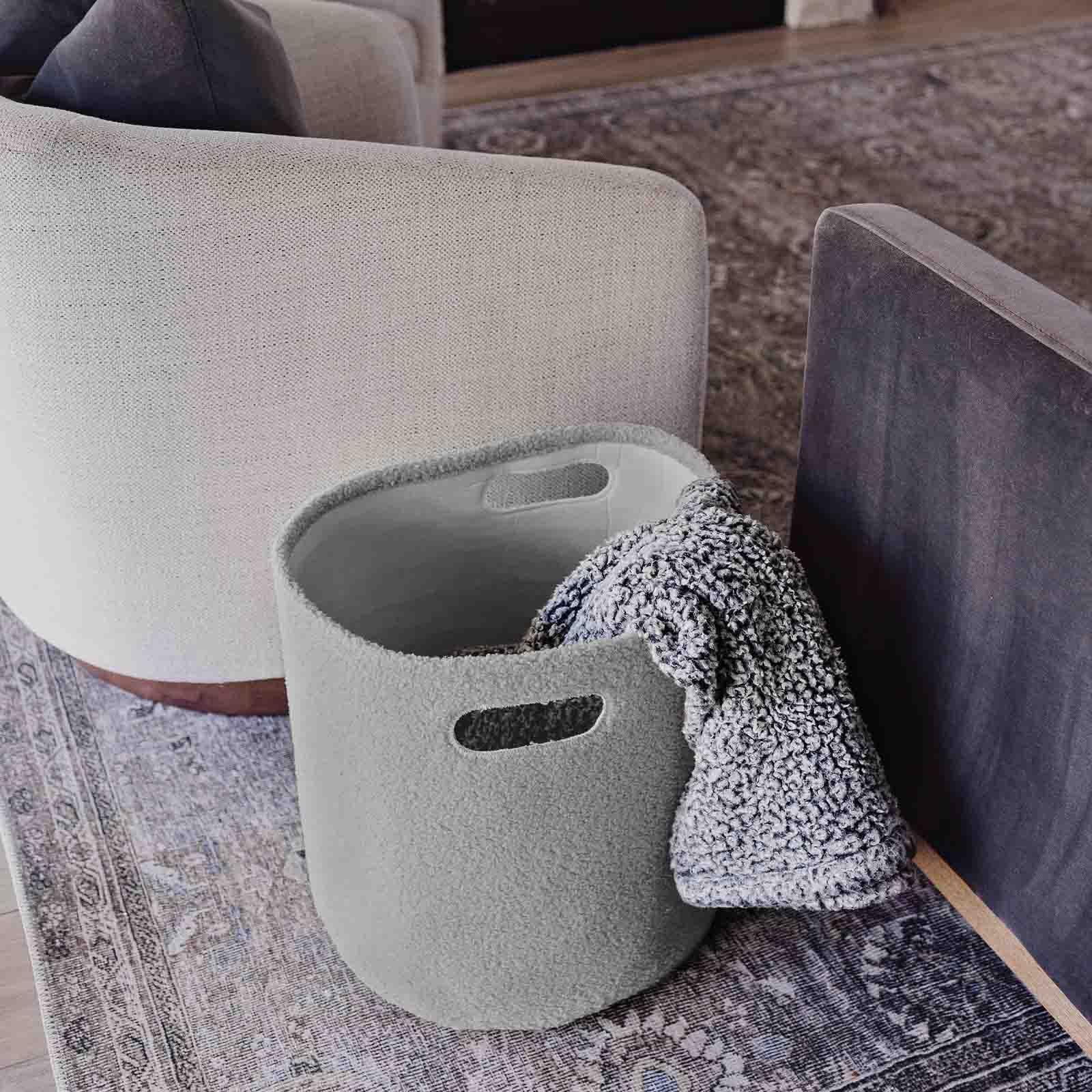 PUTSKA basket round grey in kids room illustrates decluttering and decorative organization.