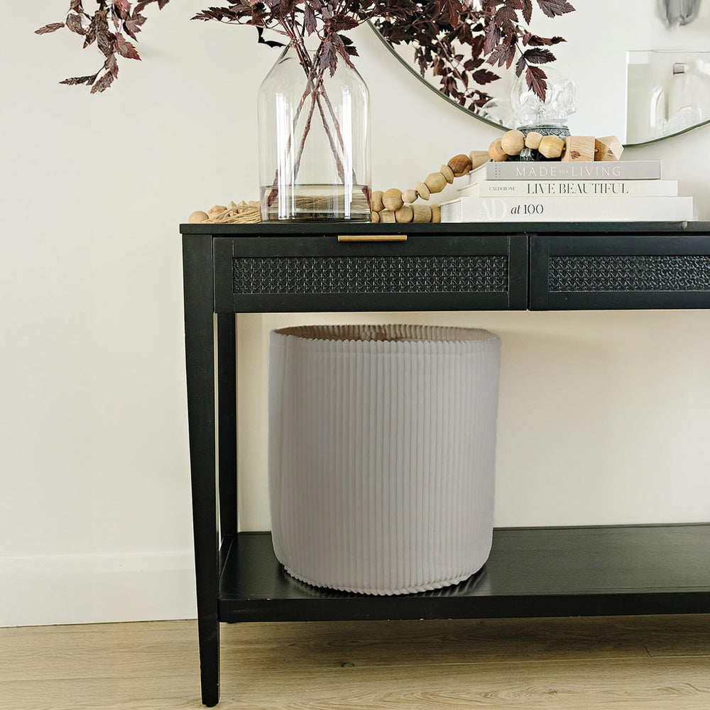 PUTSKA round blanket basket hides daily items in living room.