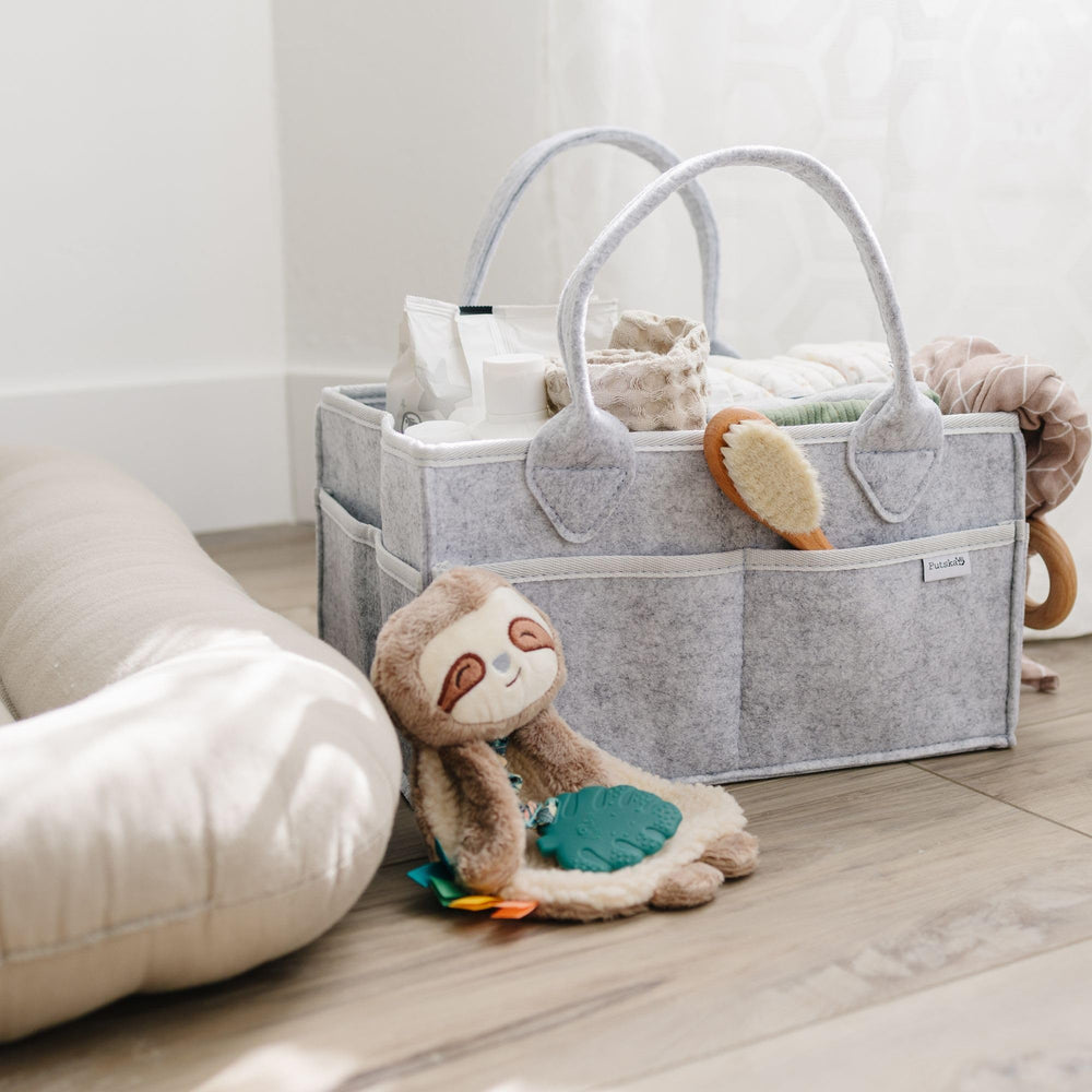PUTSKA diaper caddy external pockets filled with wipes and creams.