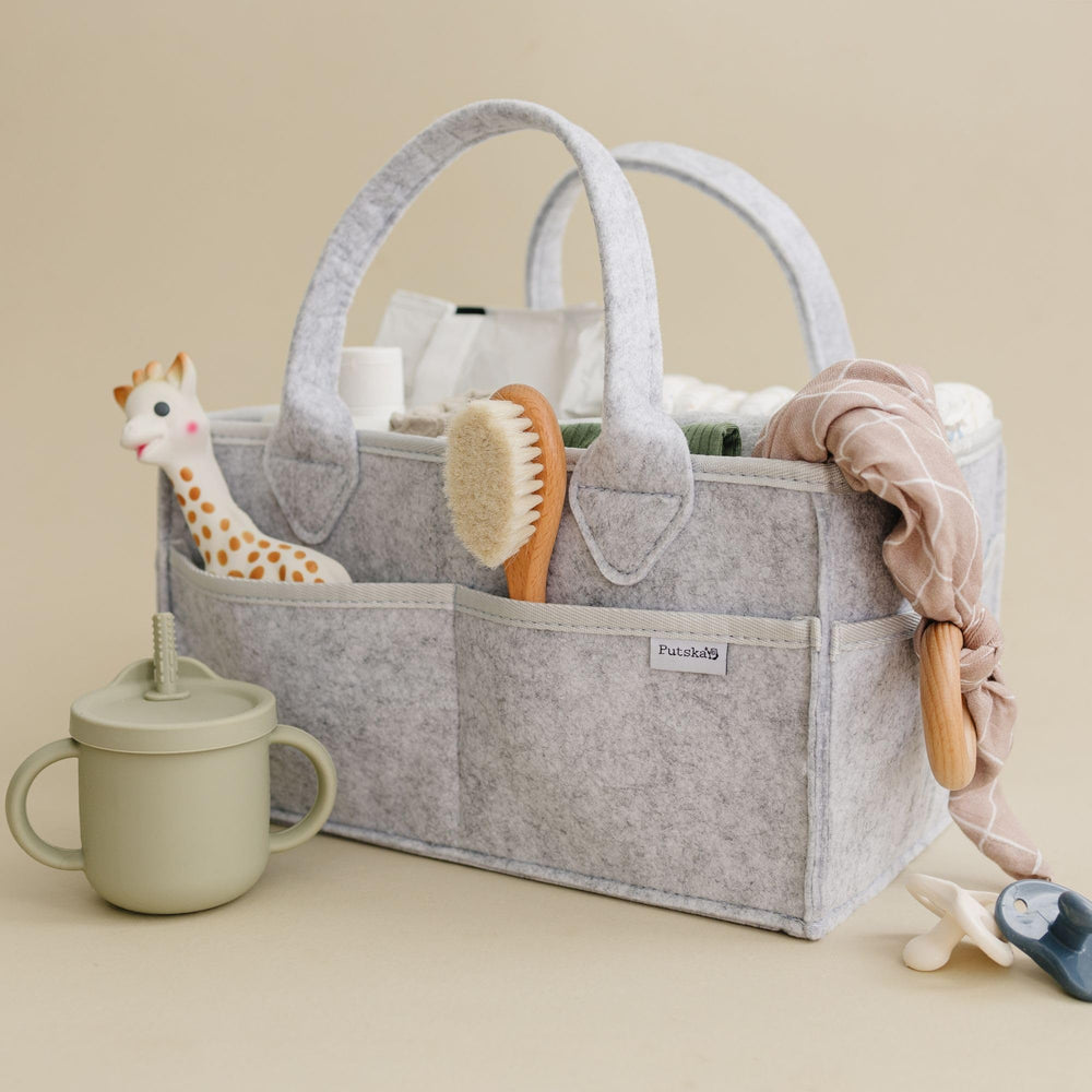 PUTSKA diaper caddy as nursery décor enhancing a grey theme.