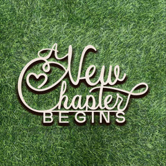 Qualiassu A New Chapter Begins wood sign on wall creates a welcoming bridal backdrop