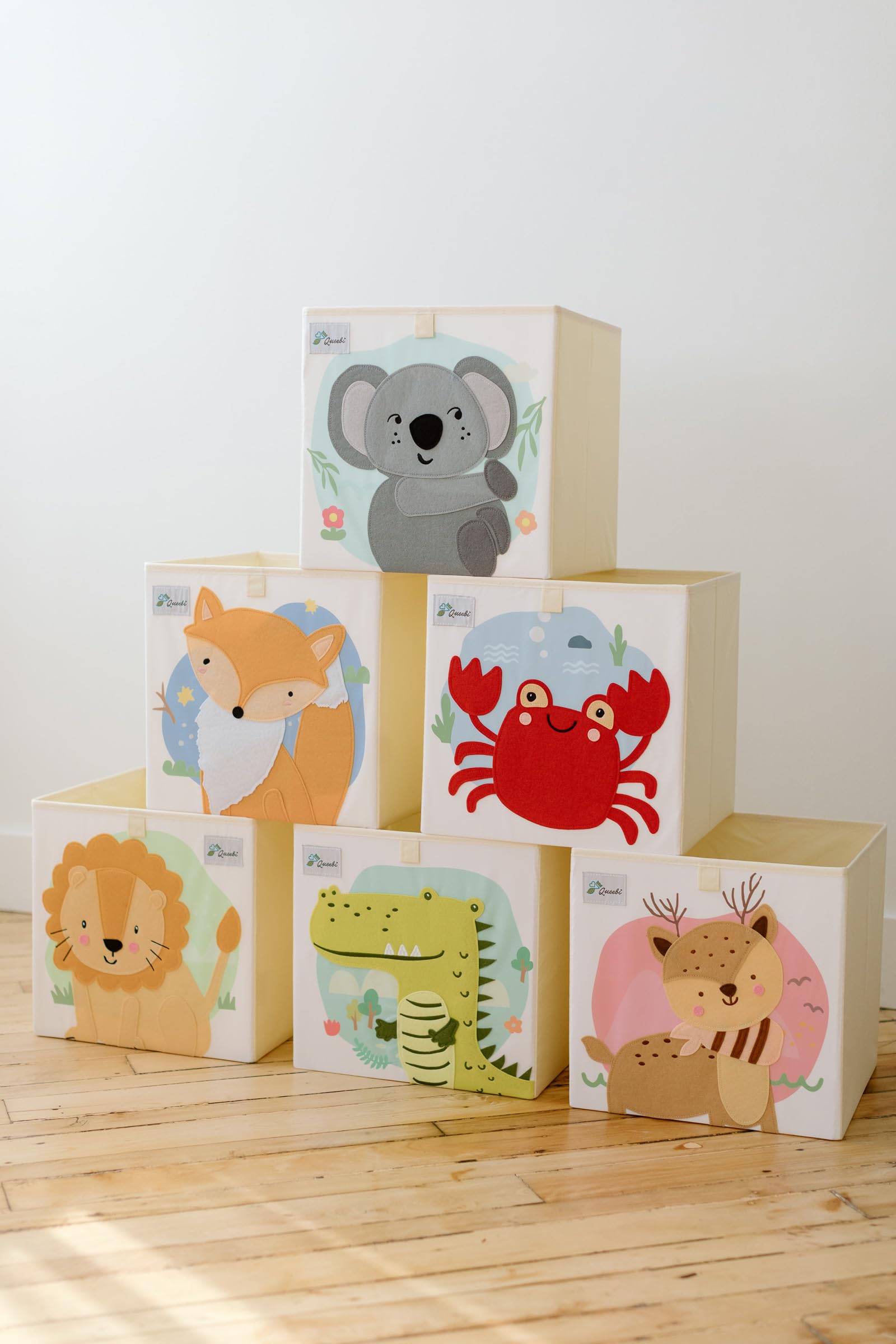 Queebi Koala storage cube under crib setup keeps essentials handy.