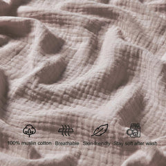 QUENESS muslin crib sheet khaki close-up, fabric texture highlights softness and airiness.