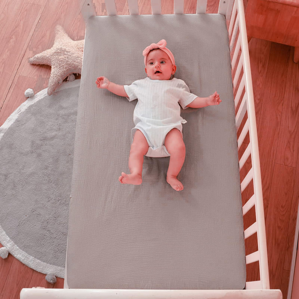 QUENESS muslin crib sheet khaki neutral tone complements various nursery decor.