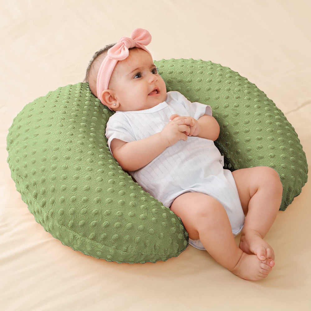 Baby learning to sit benefits from steady support