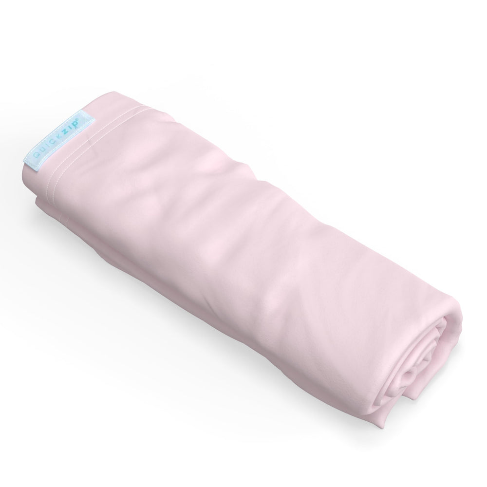 QuickZip crib extra zip-on sheet blush—easy on/off for quick changes.