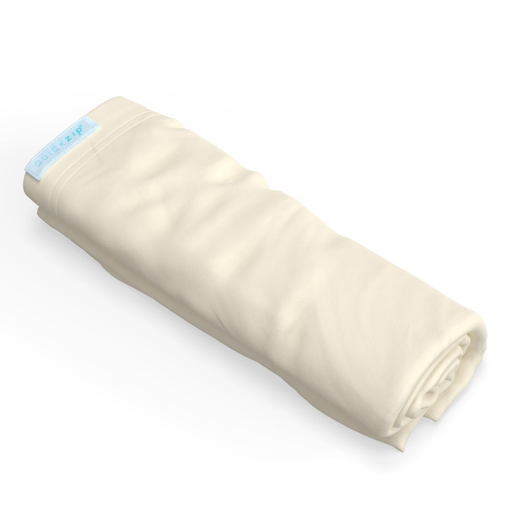 QuickZip Crib Extra Zip-On Sheet Ivory on mattress showing easy fit for quick changes.