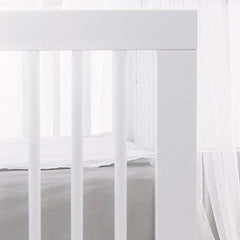 QuickZip SecureFit wraparound base detail ensures snug hold on a standard crib mattress.