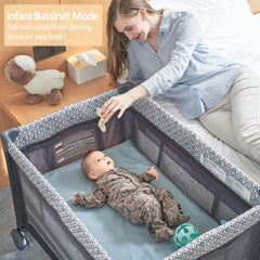 QUTANIX foldable baby crib-bassinet setup for nap time on the go.