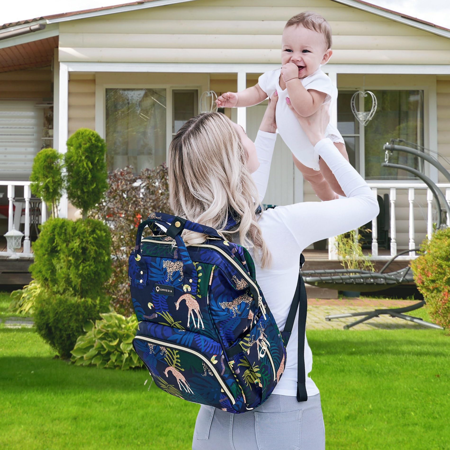 QWREOIA diaper bag in neutral animal print adds chic practicality.