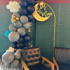 QWTOWFM Over The Moon sign used as centerpiece for baby shower decor.