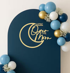 QWTOWFM We Are Over The Moon sign backdrop for celestial baby showers and festive photo moments.
