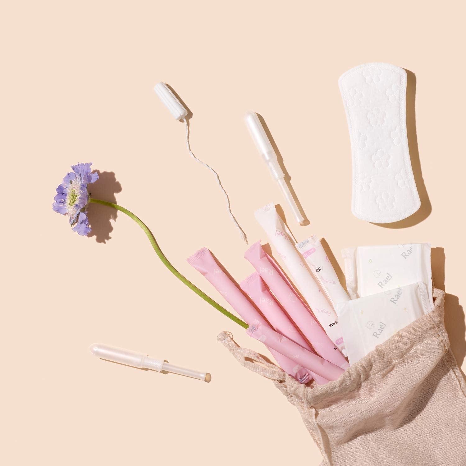 Rael flatlay with product and branding suggests simple, natural period care.