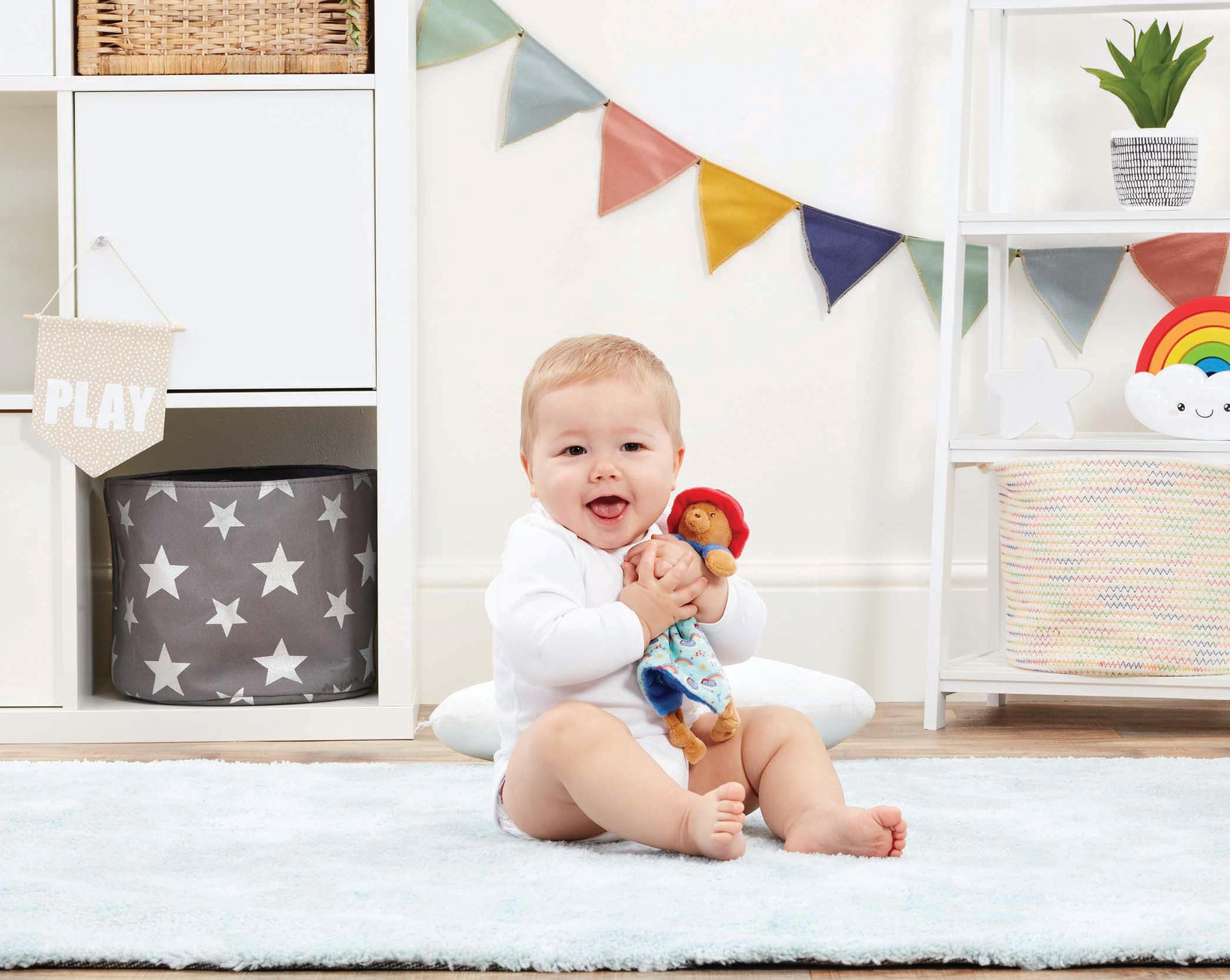 Rainbow Designs Paddington Comfort Blanket laid beside a baby to show size and reach