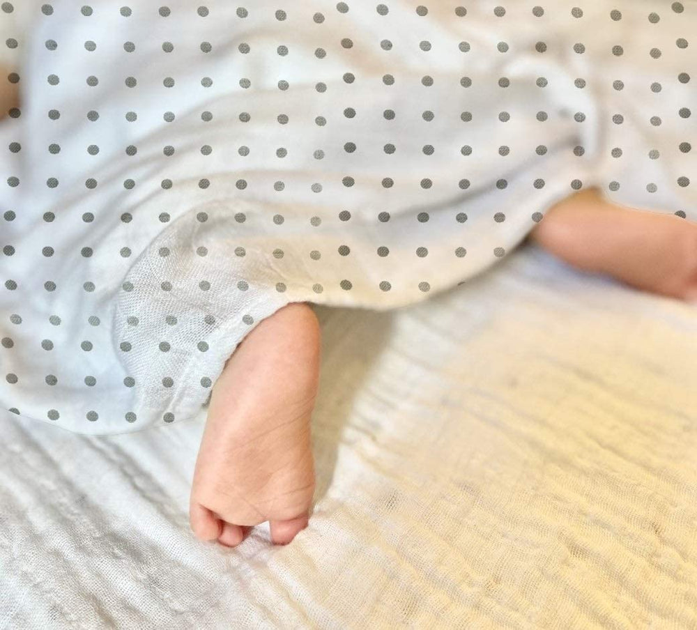 Rajlinen baby wrapped in a 47x47 swaddle for cozy, secure positioning.