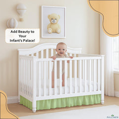 Rajlinen sage-tone ruffled crib skirt enhances nursery style.