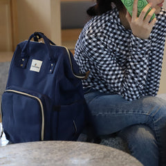 Ramhorn blue diaper bag backpack with stroller attachment for easy travel.