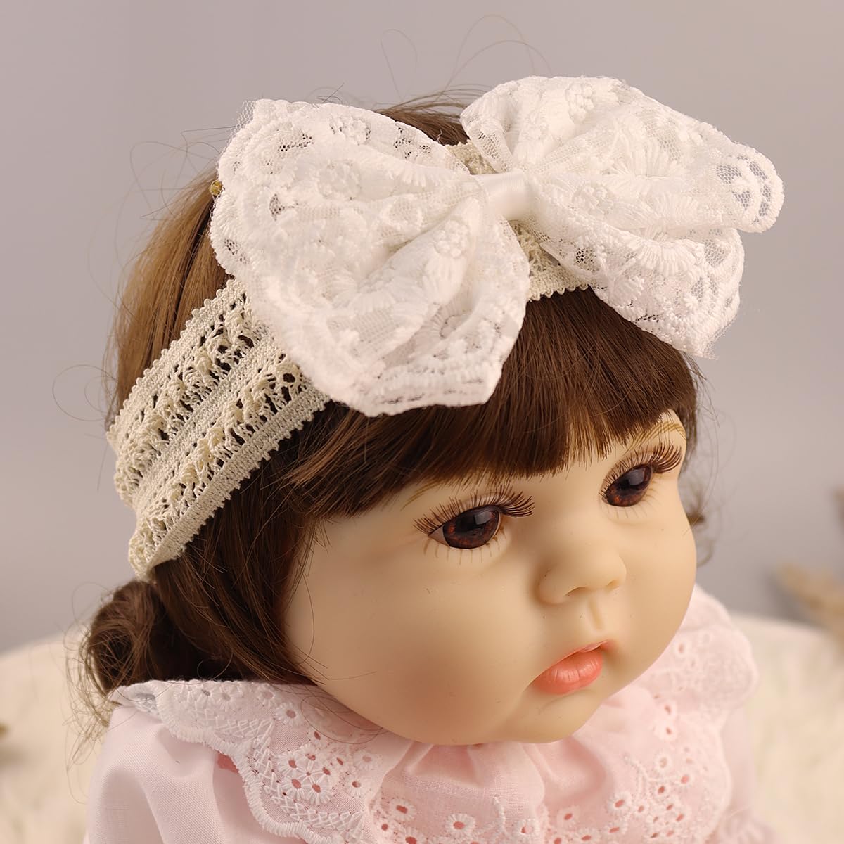 Rannyrena baby headband lace detail close-up with pearl embellishment