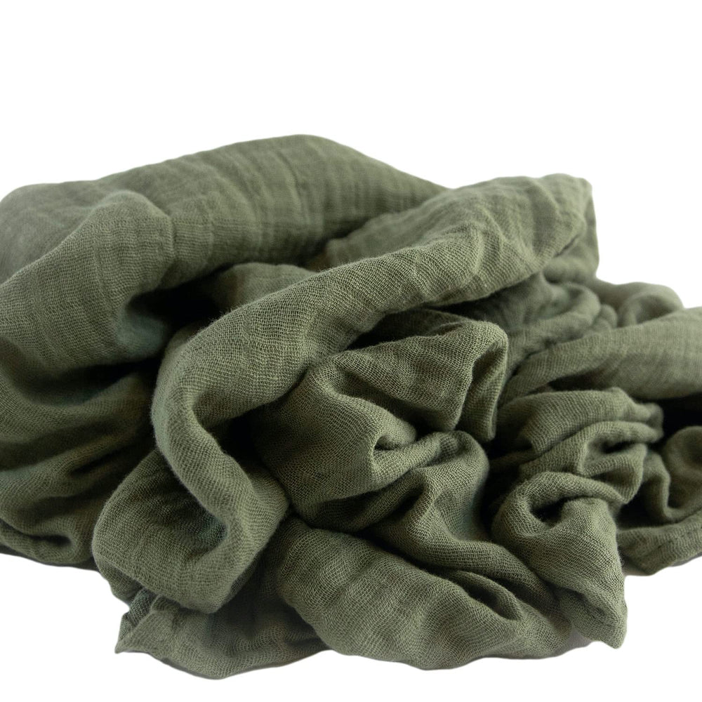 In a nursery setting, Red Rovr swaddle demonstrates versatile use during tummy time