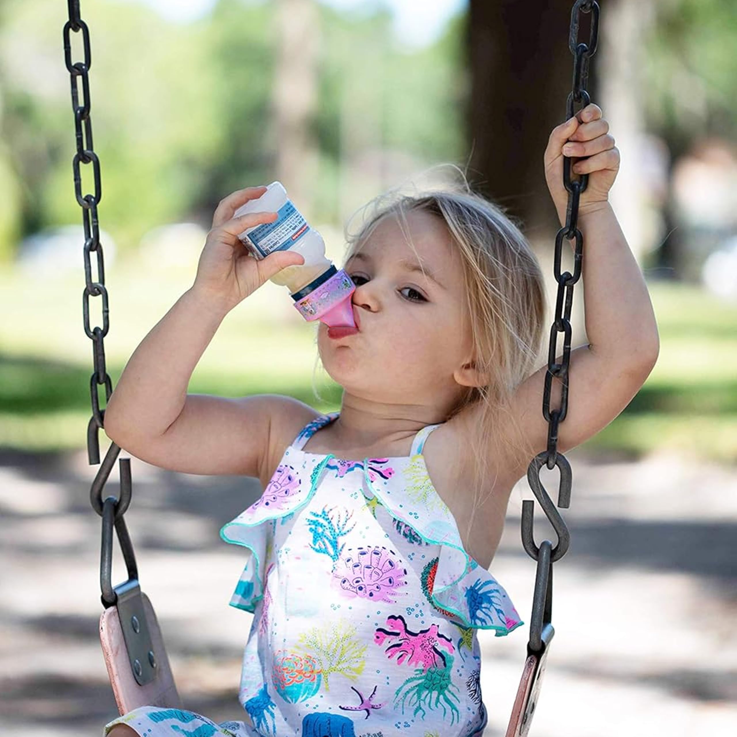 Refresh-a-Baby unicorn design spout adapter shown in use during a family outing.