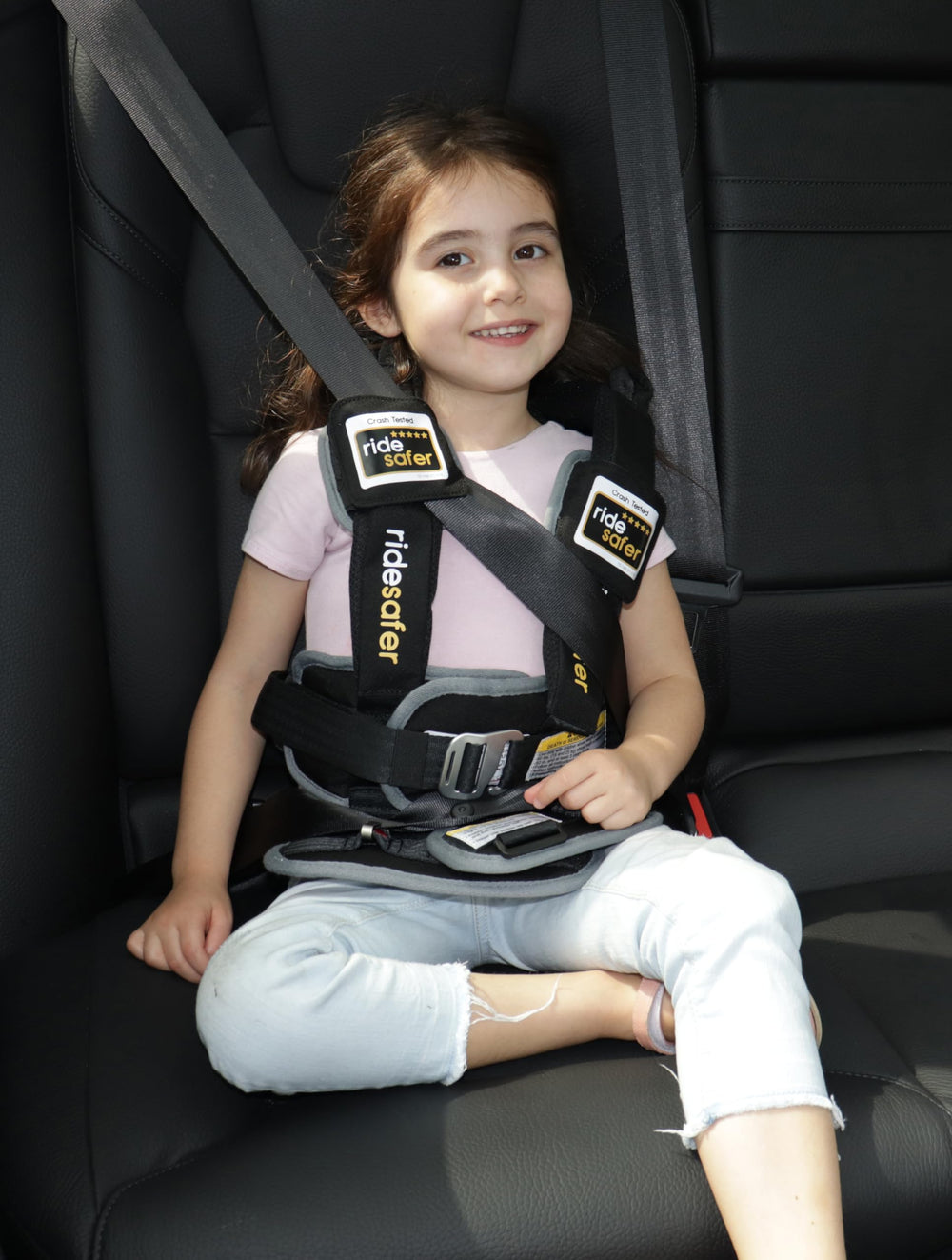 RideSafer X-Large blue car-seat belt fit demonstrated in vehicle.