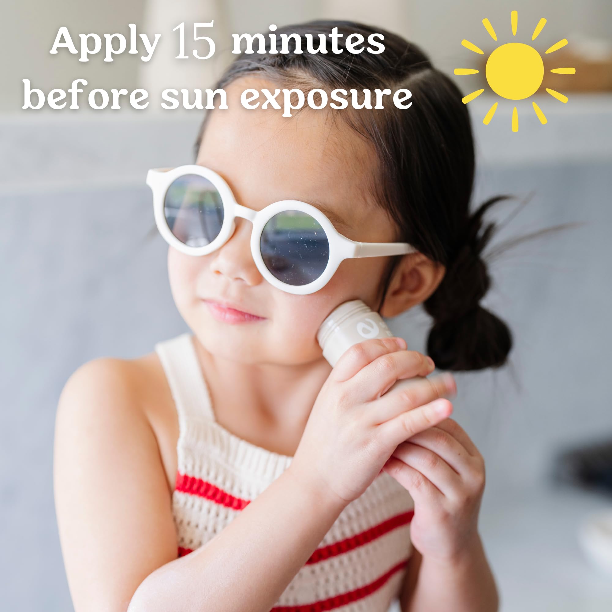 Roe Wellness sunscreen stick applied to a toddler's cheek for easy on-the-go sun protection.