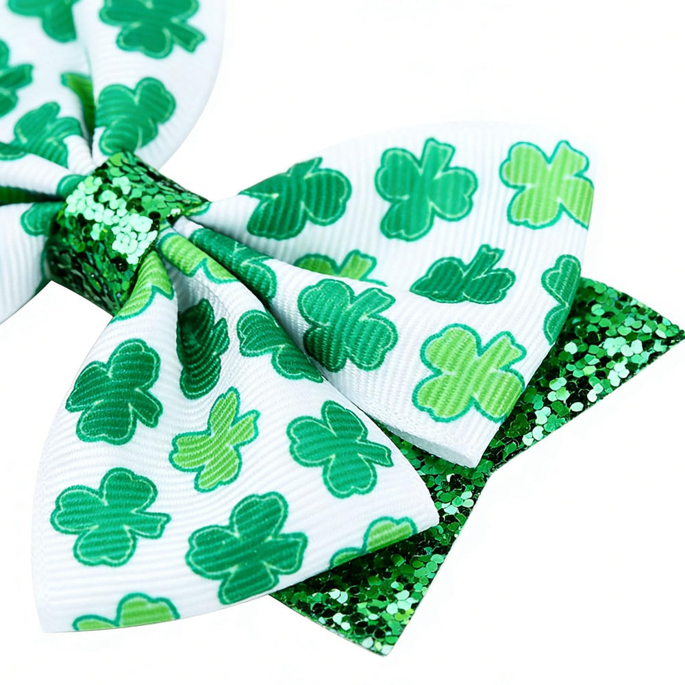 Roffiy glittery four-leaf clover bow clip flat lay for festive styling.