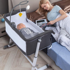 RONBEI bassinet with wheels for easy room sharing near the bed.