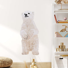 Applying RoyoLam polar bear wall sticker on a clean nursery wall.