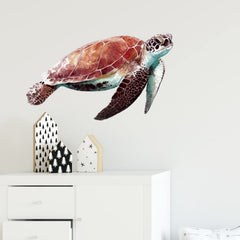 RoyoLam sea turtle wall decal being applied on wall