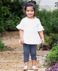 Model wearing RuffleButts headband with blue denim look in a playful outfit