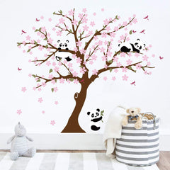 Runtoo Panda wall decal with cherry blossoms enhances living room ambiance.