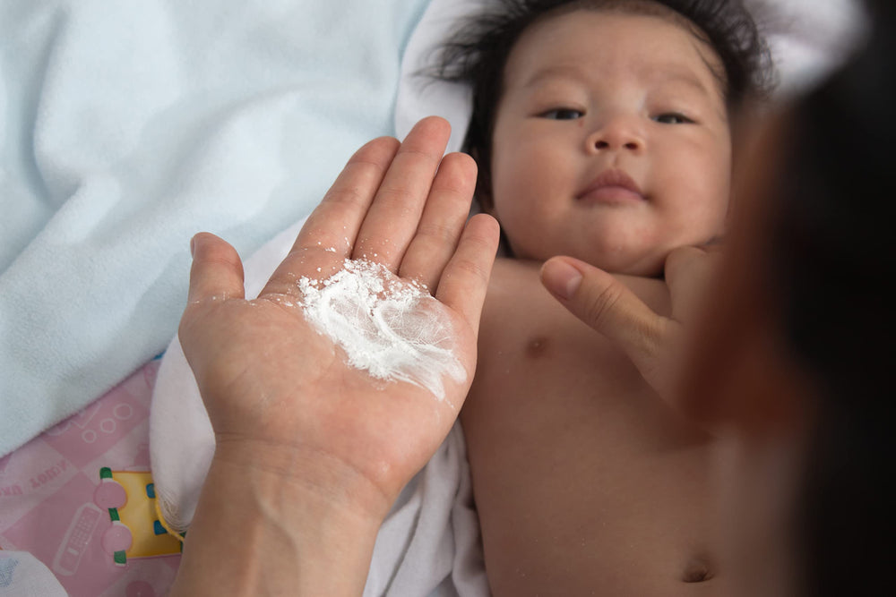 Safflower Safari Herbal Baby Powder texture closeup, talc-free formula feels silky on skin