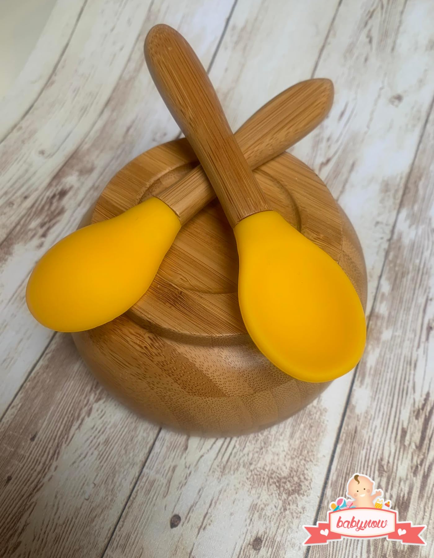 SAN SERO toddler spoon with ergonomic design in yellow.