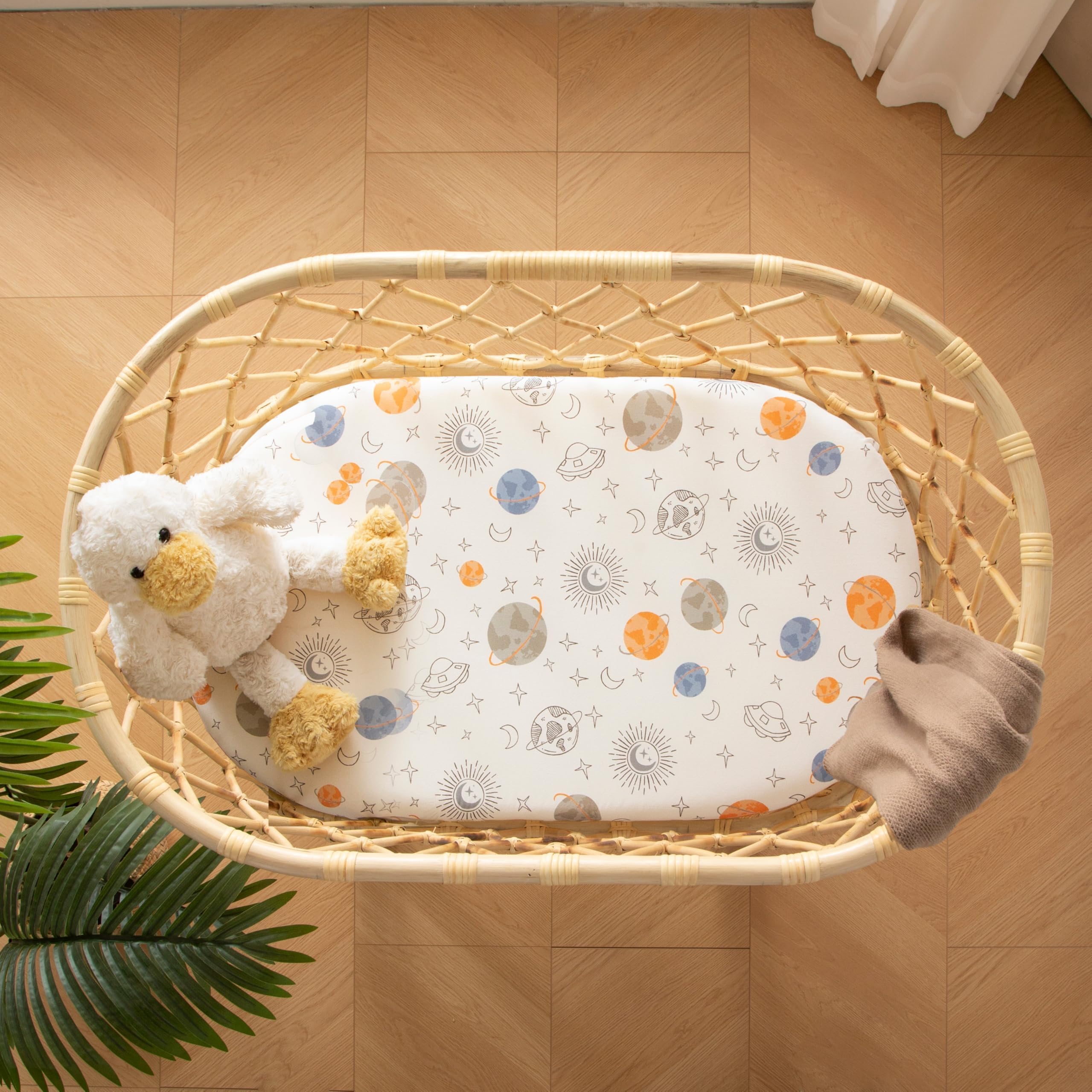 SDIII outer space bassinet sheets in use with snug elastic edges.