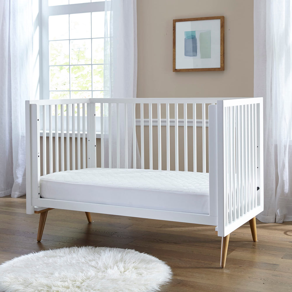 Sealy Baby pad with SecureStay skirt on crib for a snug fit.
