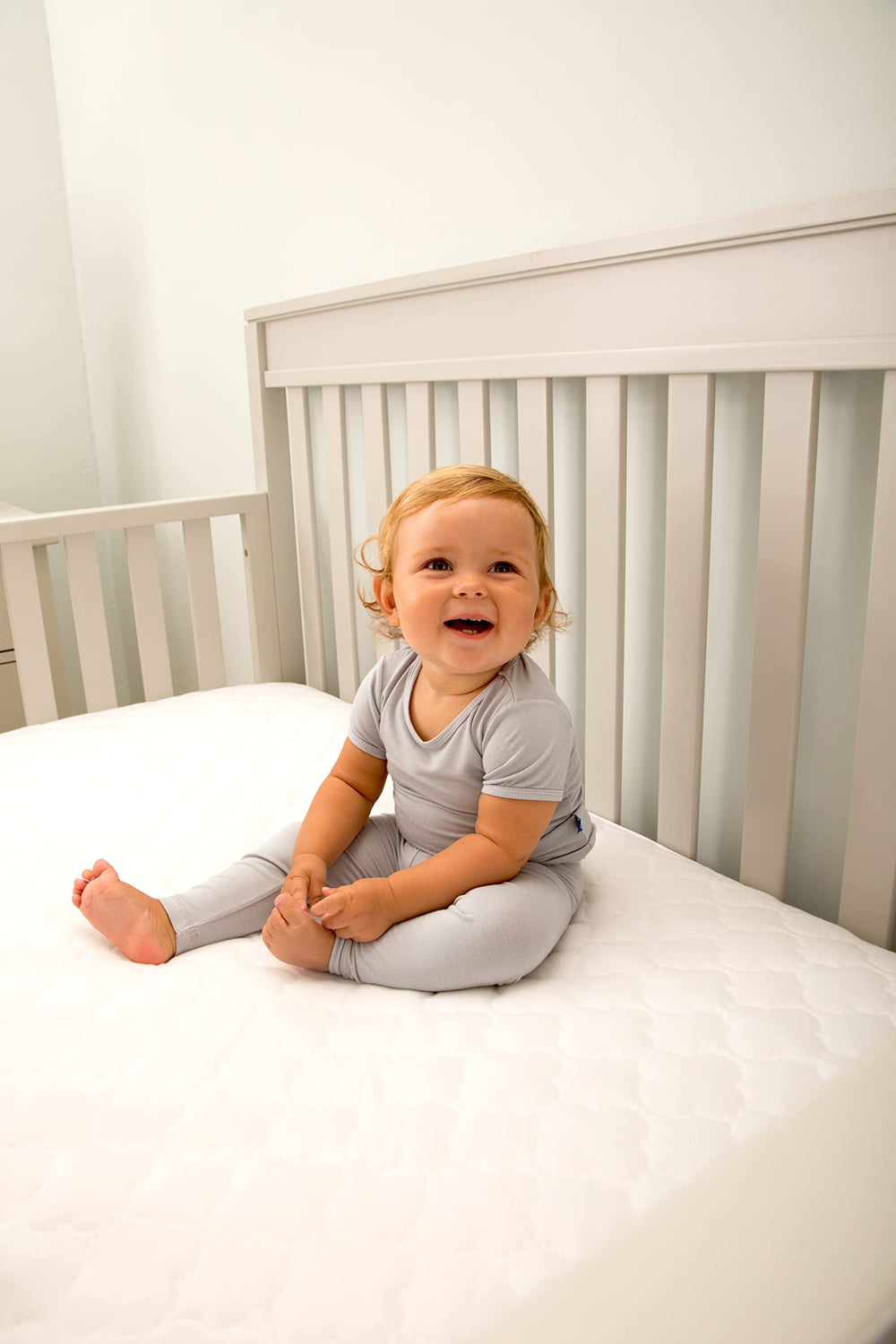 White nursery look with Sealy Baby pad for a fresh atmosphere.