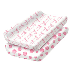 Sel Natural 2-pack changing pad covers in polka dots for secure diaper changes.