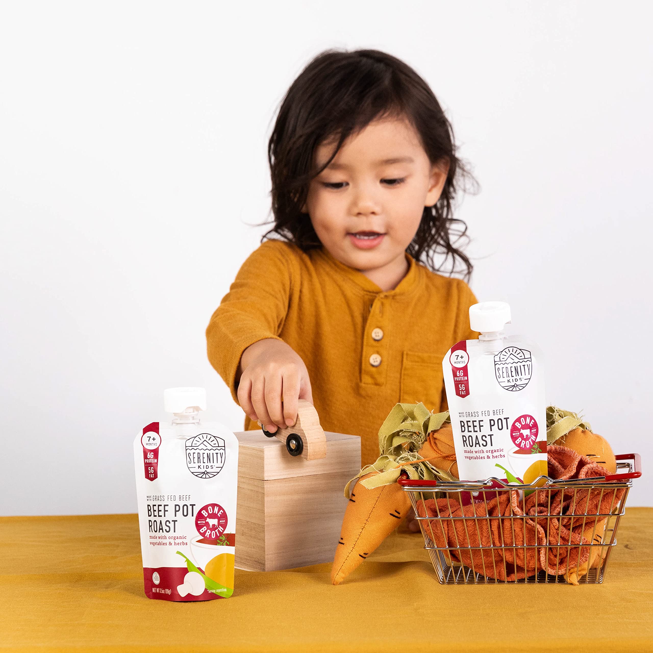 Serenity Kids pouch being squeezed for on-the-go feeding during a busy day.