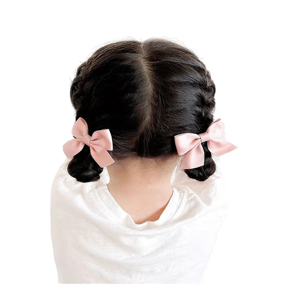 SEVENHEAD bow hair clip in use on a small child with a cute outfit
