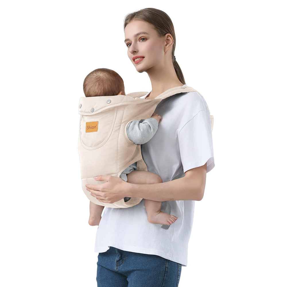 Shiaon baby carrier beige demonstrating ergonomic M-position for hip-friendly seating